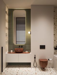 a bathroom with a sink, toilet and mirror