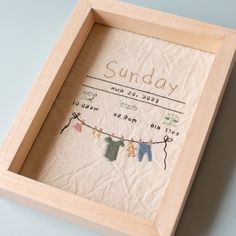 a wooden frame with some clothes hanging from it's sides and the words sunday written in cursive writing