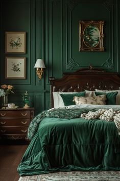 a bedroom with green walls and bedding in the center, along with pictures on the wall