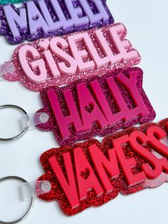 three name tags with glitter on them