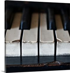 the keys of an old piano are black and silver