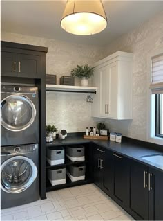 a washer and dryer sitting in a kitchen next to each other on top of cabinets