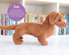 a brown stuffed dog standing on top of a white table next to bookshelves