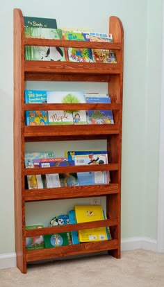 the bookshelf is made out of wood and has several shelves for children's books