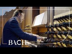 a man playing an organ in front of a wall