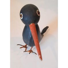 a toy bird with a long red beak