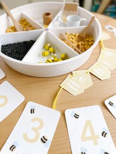 a wooden table topped with lots of different types of cards and numbers on top of it