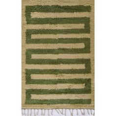 a green and beige rug with fringes on it