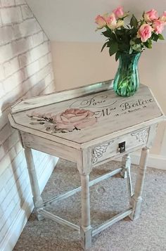 a vase with flowers on top of an old table