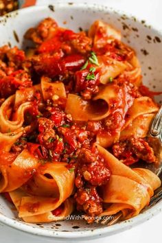 a white bowl filled with pasta and sauce