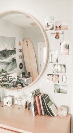 there is a mirror on the wall above a desk with a surfboard in it