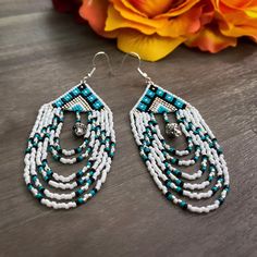 Southwestern inspired beaded fringe earrings made with Miyuki Delica Beads and silver spacer beads. Beads With Beaded Fringe For Jewelry Making, Dangle Beads With Beaded Fringe For Jewelry Making, Southwestern Beaded Dangle Earrings, Southwestern Beaded Fringe Dangle Earrings, Southwestern Style Beaded Dangle Earrings, Southwestern Style Beaded Fringe Dangle Earrings, Bohemian White Beaded Earrings With Silver Beads, Bohemian Teardrop Beaded Earrings With Spacer Beads, White Bohemian Beaded Earrings With Silver Beads