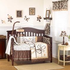 a baby crib in a room with pictures on the wall