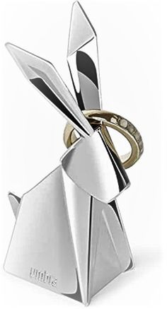 a silver rabbit shaped object with two rings on it's back end and one ring in the middle