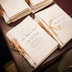 the wedding stationery is laid out on top of each other and ready for guests to arrive