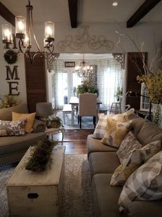 a living room filled with furniture and lots of pillows on top of it's couches