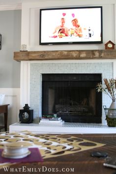 a flat screen tv mounted above a fireplace