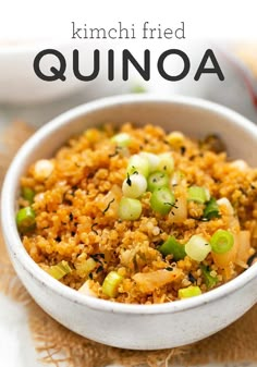 a white bowl filled with fried quinoa on top of a wooden cutting board