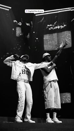 two young men standing on top of a stage