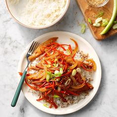 a white plate topped with rice and veggies