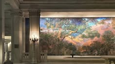 a large painting in the middle of a building with columns and chandeliers on either side