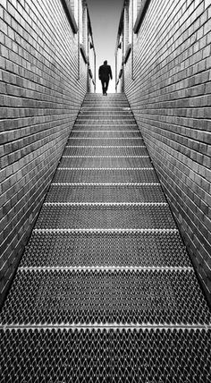 a man is walking up some stairs