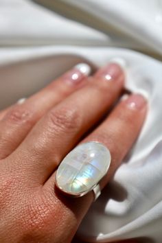 Catch yourself staring at this beautiful rainbow moonstone ring as it captures the light and glows everywhere you go. This ring is also adjustable! The shank allows the wearer to adjust the band smaller or larger about a size. I recommend picking your desired size regardless and you can adjust larger it to fit your other fingers. I'm also debating making this ring in yellow gold.. Please allow up to two weeks for orders on this design as they are each handmade. Spiritual Adjustable Moon-shaped Moonstone Ring, Unique Adjustable Oval Moonstone Ring, Adjustable Moonstone Ring For Healing, Adjustable Moonstone Healing Ring, Minimalist Adjustable Moonstone Ring With Natural Stones, Unique White Adjustable Moonstone Ring, Unique Adjustable White Moonstone Ring, Adjustable Mystical Moonstone Ring With Natural Stones, Adjustable Moonstone Crystal Ring With Open Design