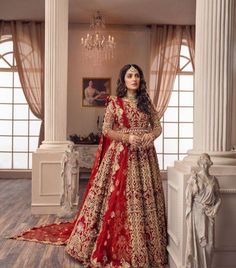 a woman in a red and gold bridal gown