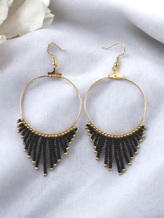 These beaded hoop fringe earrings in gold and black are stunning statement pieces, perfect for adding a touch of elegance to any party outfit. Crafted with seed beads, they make a thoughtful gift idea for your daughter, combining fashion-forward design with wearable neutral art. These hoop earrings are the perfect gift for a wedding, birthday, Christmas, anniversary, engagement, Mother's Day, Valentine's Day, woman's day, bridesmaid proposal, and many more. ABOUT * Beaded earrings * Hoop style * Black Statement Earrings, Neutral Art, Earrings Hoop, Earrings In Gold, Beaded Hoops, Party Jewelry, Fringe Earrings, Bridesmaid Proposal, Jewelry Earrings Hoops