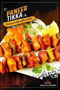 there is a white plate with food on it and the words paneer tikka above it