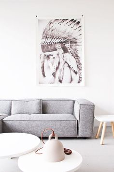 a living room filled with furniture and a painting hanging on the wall above it's headdress