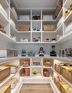 an organized pantry with white shelving and lots of food