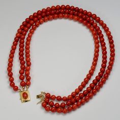 This beautiful 14k gold Vintage bead necklace shows off 3 full strands of natural Sardinia Coral polished rounds from Italy. Makes quite a statement! The necklace would be worn as a choker, as the smallest strand is 14 inches in length. The longest is 18 inches. The coral is a medium shade red and is of even color throughout the strands. The gold clasp is 14k gold and holds the ends of the 3 strands of coral bead necklaces. It has a faceted oval coral set in the middle and has a latch on the sid Gold Multi-strand Hand-strung Necklace, Gold Double Strand Hand-strung Necklace, Luxury Multi-strand Gemstone Beads Necklace, Elegant Hand-strung Double Strand Necklaces, Luxury Gold Hand-strung Necklaces, Luxury Gold Hand-strung Necklace, Luxury Hand-strung Gold Necklace, Coral Beads Necklace, Vintage Beads Necklace