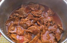 a pot full of meat and sauce sitting on a table