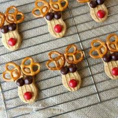 some pretzels are decorated like reindeers and rudolph's nose is sticking out of them