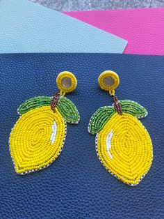 Beautiful colors lemon Yellow and a variety of leaf green seed beads were used to create these beautiful indigenous style lemon push back earrings.  These wonderful earrings would make a great addition to any wardrobe.  Each item is hand beaded and made personally, creating a unique item that is one of a kind made just for you! Please contact us if you have any questions. Thank you for looking and have a great day! Yellow Earrings With Large Round Beads, Yellow Beaded Earrings For Summer, Indigenous Beaded Earrings, Indigenous Style, African Earrings, Leaf Green, Lemon Yellow, Hand Beading, Have A Great Day