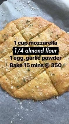 a pizza sitting on top of a table covered in floured dough and toppings