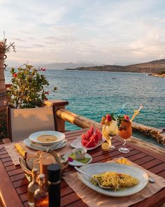 the table is set for two on the deck overlooking the water