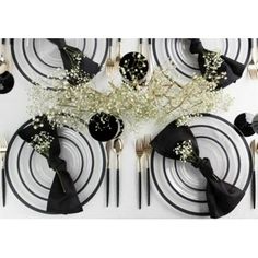 black and white place setting with baby's breath centerpieces, silverware and flowers