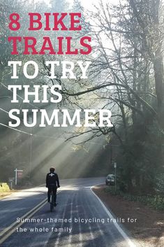 a man riding a bike down a road with the words 8 bike trails to try this summer