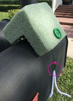 an inflatable object with a green button attached to it sitting on the ground