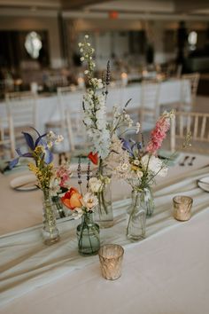 The soft white Ballroom was filled with lush blooms, bud vases and lots of candles- the perfect gardenesque reception! Love Is In Bloom Table Decor, Vases With Flowers, Wildflower Baby Shower, Wedding Tables, Garden Party Wedding, 2024 Wedding, Colorful Wedding, Wildflower Wedding, Wedding Mood