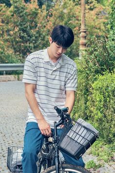 a young man sitting on top of a bike