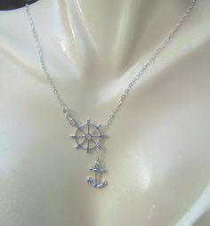 "Here is a cute sterling ship's wheel charm along with a sterling anchor in a lariat style necklace on a delicate flat link sterling chain. This is all sterling ~ NOT silver plated or \"antique silver.\" Perfect for the summer or any time you are in a nautical frame of mind. The necklace measures about 16 inches long but is adjustable when wearing depending on how you place the charm. If you need a longer chain, this is also available in an 18 inch length. Perfect for a casual look with jeans or Nautical Style Adjustable Jewelry Gift, Adjustable Nautical Style Jewelry For Gifts, Nautical Style Metal Jewelry Gift, Silver Nautical Jewelry With Adjustable Fit, Adjustable Nautical Silver Jewelry, Nautical Frame, Navy Girlfriend, Lariat Style Necklace, Ships Wheel