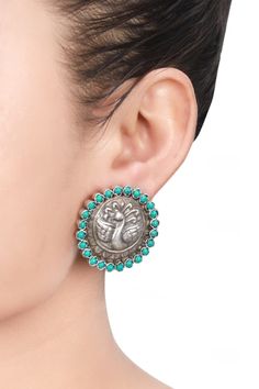 Silver toned stud earrings with peacock motif carvings and stone studded hem.
Type: Stones
Composition: Silver
Color: Silver
Handcrafted earrings
Peacock motifs
Closure: Push back
Note:  The jewellery is handcrafted therefore variations may occur - Aza Fashions Sterling Silver Peacock Design Jewelry, Sterling Silver Round Peacock Design Jewelry, Round Peacock Design Earrings As Gift, Fusion Style Peacock Design Earrings, Silver Round Earrings With Peacock Design, Fusion Style Peacock Design Earrings For Gift, Traditional Round Peacock Design Earrings, Peacock Motifs, Peacock Motif