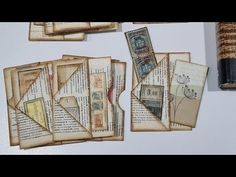 several pieces of old paper are displayed on a table with a pen and ink roller