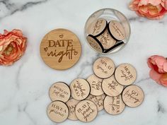 personalized wooden magnets with date night written on them next to pink flowers and a glass jar