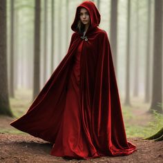 a woman wearing a red cloak in the woods