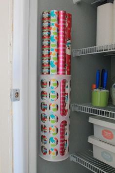 rolls of toilet paper are on the shelf in the closet next to the refrigerator door