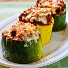 three stuffed zucchini shells on a white plate